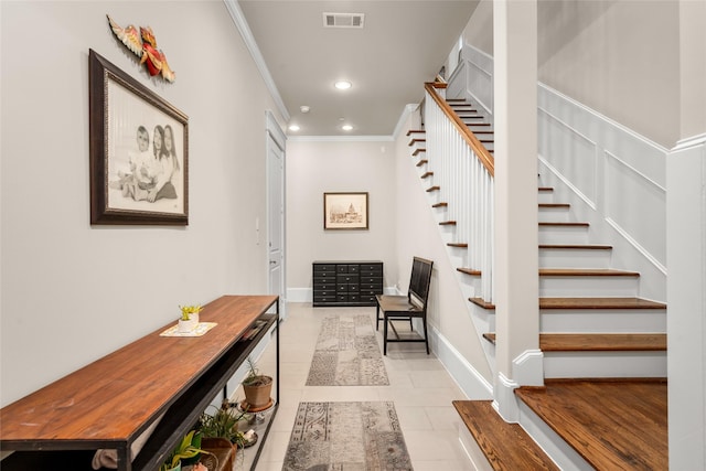 hallway featuring light tile patterned flooring and ornamental molding