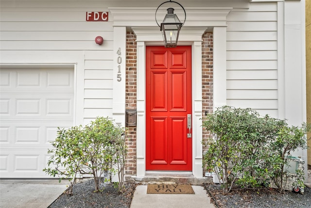 doorway to property with a garage