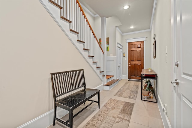 entrance foyer with ornamental molding and light tile patterned flooring