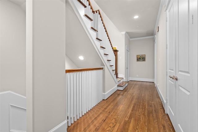 corridor featuring hardwood / wood-style floors and ornamental molding