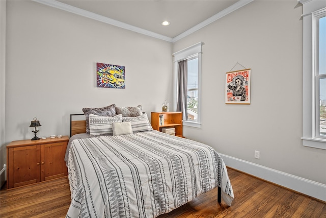 bedroom with crown molding and dark wood-type flooring