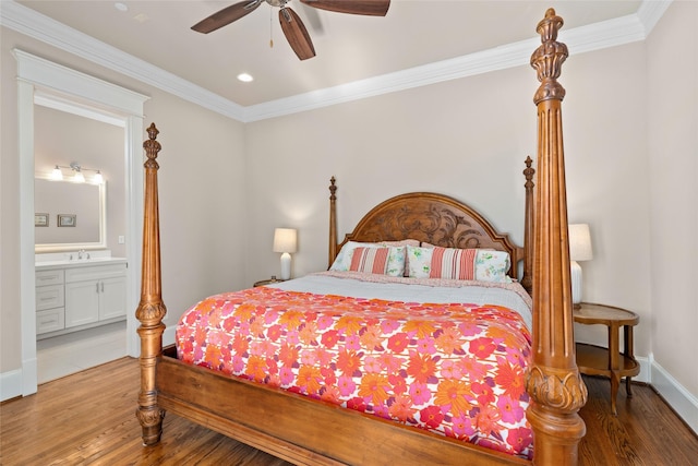 bedroom featuring sink, crown molding, wood-type flooring, and ensuite bath