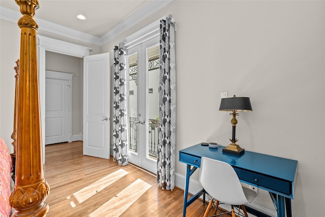 office space with french doors, ornamental molding, and light wood-type flooring