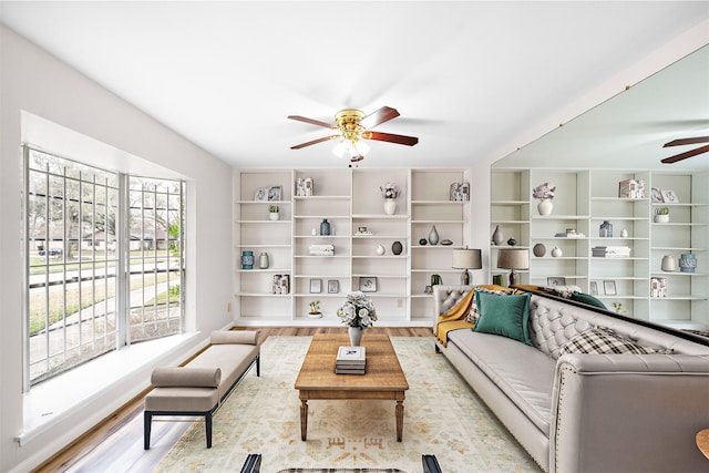 living room featuring ceiling fan and light wood-type flooring