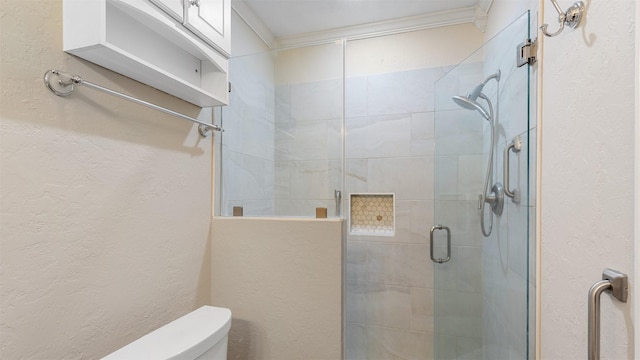 bathroom with ornamental molding, toilet, and walk in shower