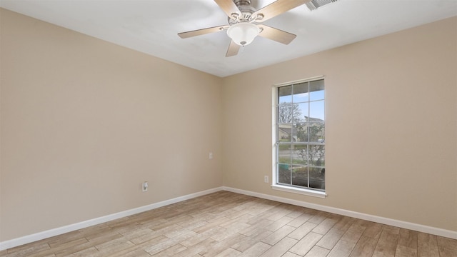 empty room with ceiling fan and light hardwood / wood-style floors