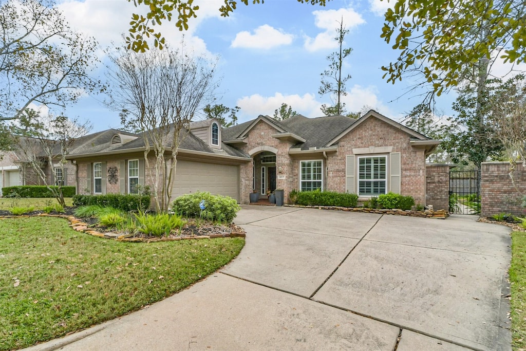 ranch-style home featuring a garage and a front lawn