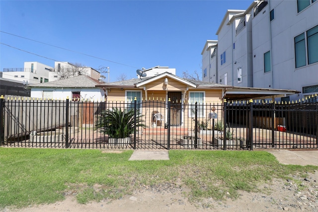 view of front of house with a front lawn and a carport