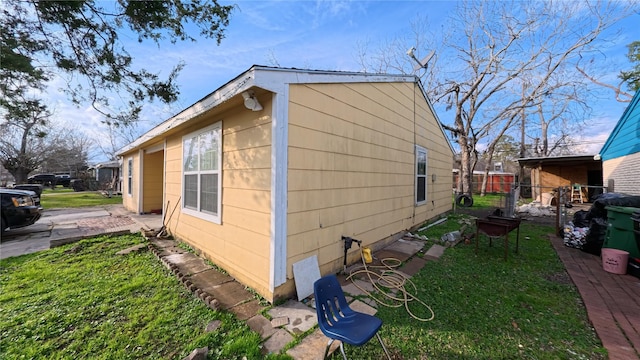 view of side of property with a yard