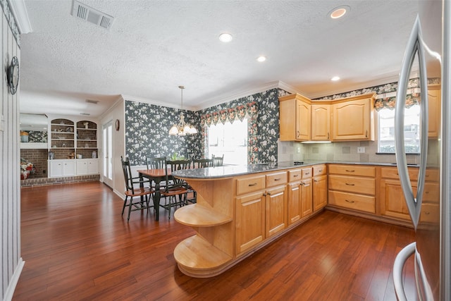 kitchen with stainless steel fridge, visible vents, dark wood-style flooring, and a textured ceiling