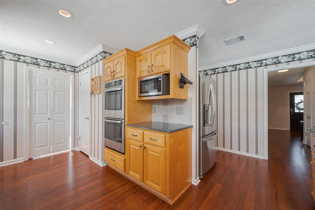 kitchen featuring appliances with stainless steel finishes, visible vents, crown molding, and wallpapered walls