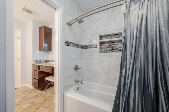 bathroom with shower / tub combo, vanity, visible vents, and baseboards