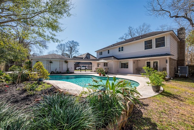 outdoor pool with a patio and central air condition unit