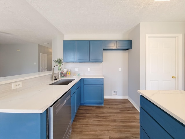 kitchen featuring blue cabinets, sink, dark hardwood / wood-style flooring, stainless steel dishwasher, and kitchen peninsula