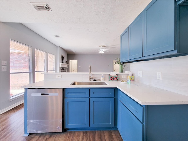 kitchen featuring plenty of natural light, sink, stainless steel dishwasher, and kitchen peninsula