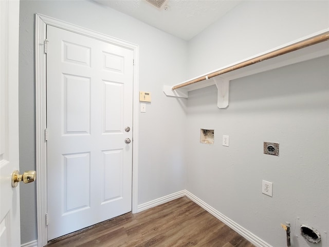 washroom featuring dark hardwood / wood-style flooring, hookup for a gas dryer, hookup for a washing machine, and electric dryer hookup