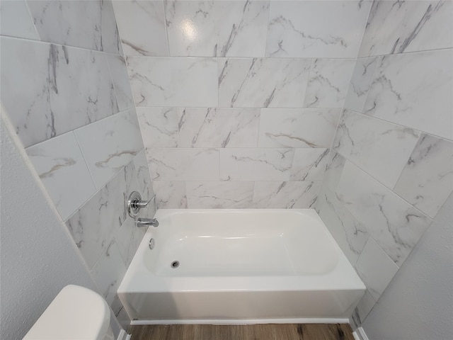 bathroom with hardwood / wood-style flooring and toilet