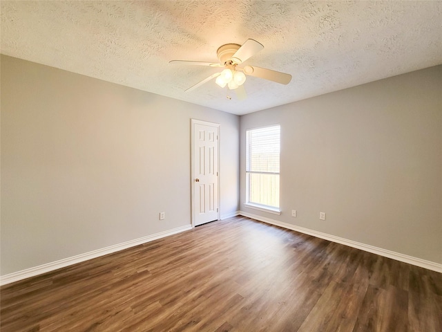 unfurnished room featuring ceiling fan, dark hardwood / wood-style flooring, and a textured ceiling