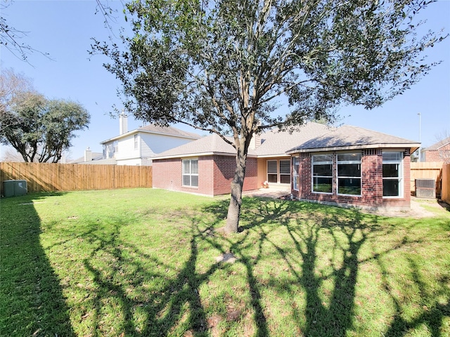 rear view of property featuring a lawn