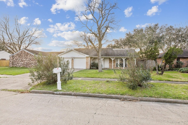 ranch-style house featuring a garage and a front yard