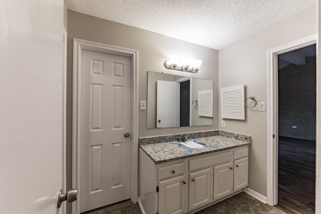 bathroom with vanity and a textured ceiling