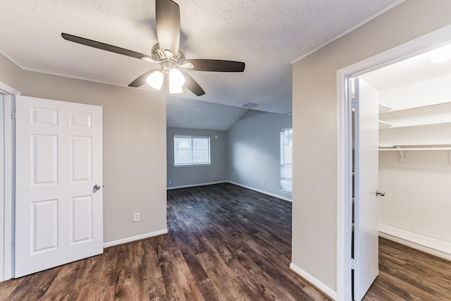 bonus room featuring ceiling fan, dark wood-type flooring, a textured ceiling, and vaulted ceiling