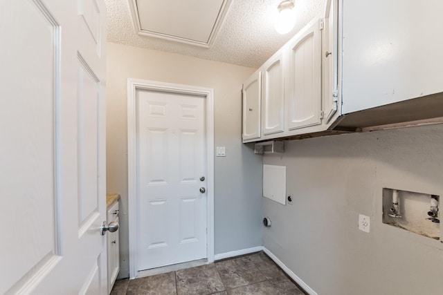 laundry area featuring cabinets, washer hookup, hookup for an electric dryer, and a textured ceiling