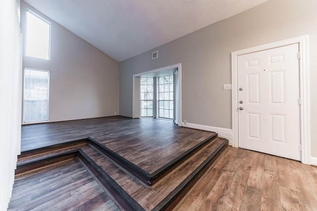 foyer entrance with lofted ceiling and wood-type flooring