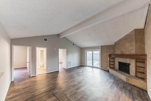 unfurnished living room with lofted ceiling with beams, dark hardwood / wood-style flooring, a textured ceiling, and a fireplace