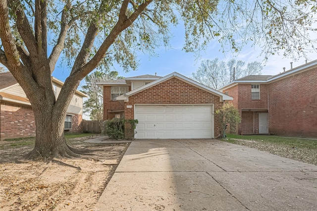 traditional-style house featuring an attached garage, brick siding, and driveway