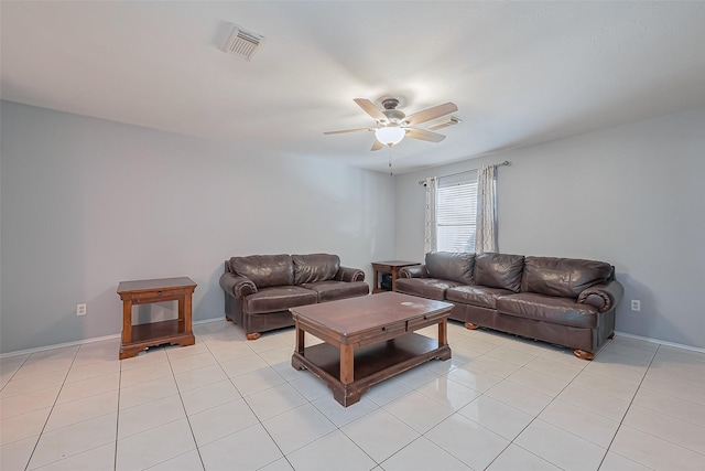 living area featuring light tile patterned floors, visible vents, baseboards, and ceiling fan