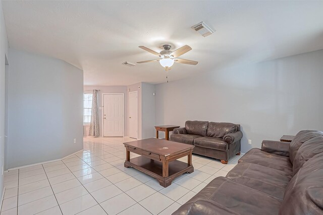 living room featuring light tile patterned floors, a ceiling fan, and visible vents