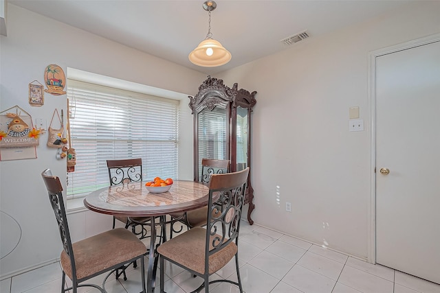 dining area with light tile patterned floors and visible vents