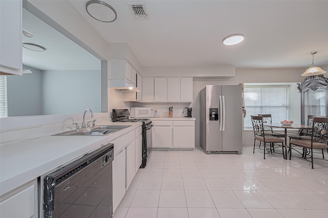 kitchen featuring dishwashing machine, white microwave, stainless steel fridge with ice dispenser, a sink, and black range with gas stovetop