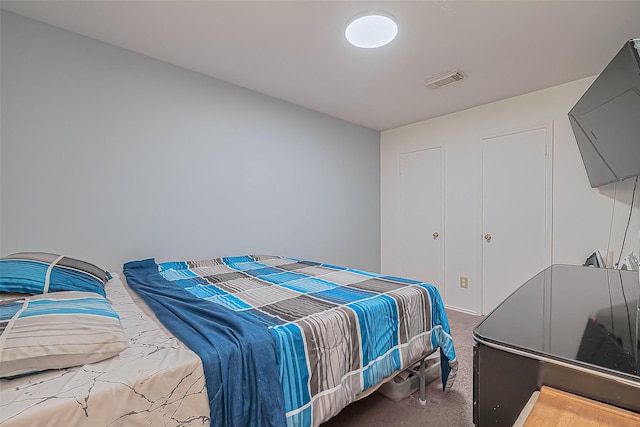 carpeted bedroom with visible vents