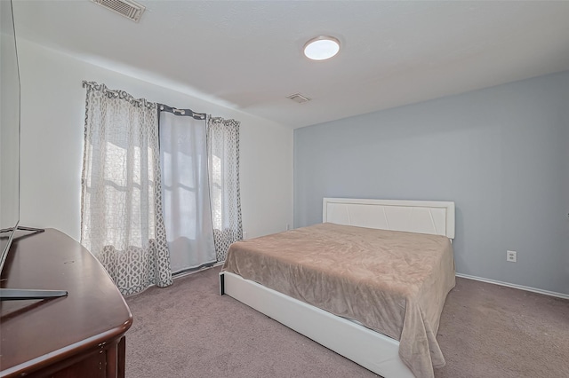 bedroom with visible vents and carpet