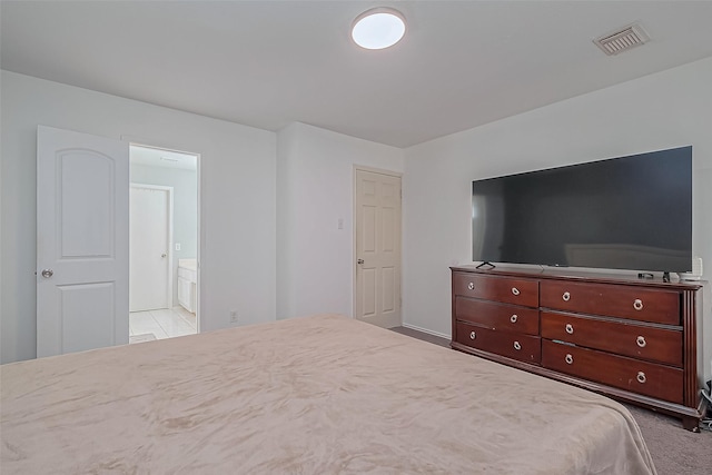 bedroom with visible vents and connected bathroom