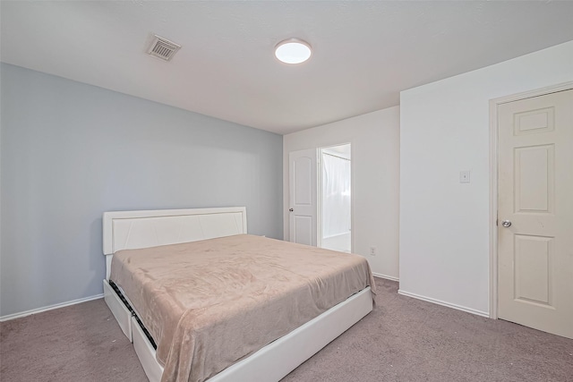 carpeted bedroom featuring baseboards and visible vents