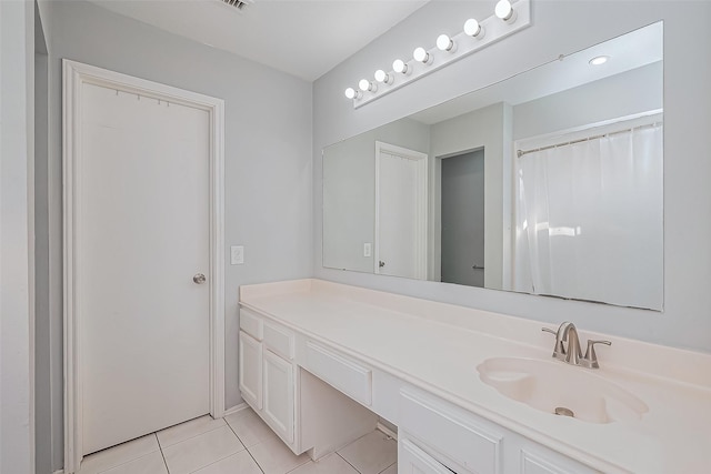 full bathroom featuring tile patterned floors and vanity