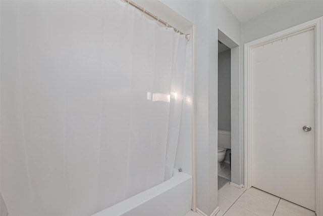 full bathroom featuring tile patterned floors and toilet