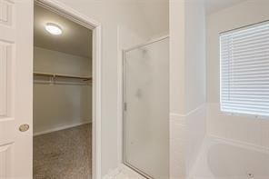 bathroom featuring plus walk in shower