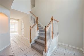 staircase featuring tile patterned flooring