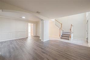 spare room featuring crown molding and dark hardwood / wood-style floors