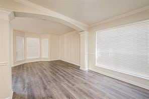 spare room with hardwood / wood-style flooring and ornamental molding