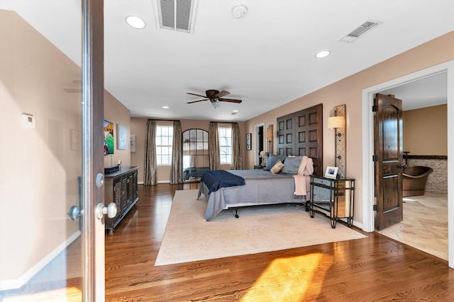 bedroom featuring recessed lighting, visible vents, baseboards, and wood finished floors