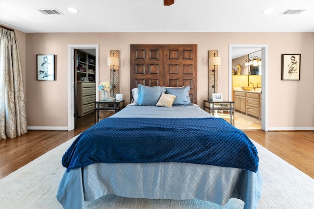 bedroom featuring recessed lighting, visible vents, baseboards, and wood finished floors