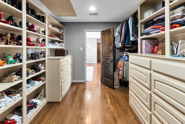 spacious closet featuring visible vents and wood finished floors