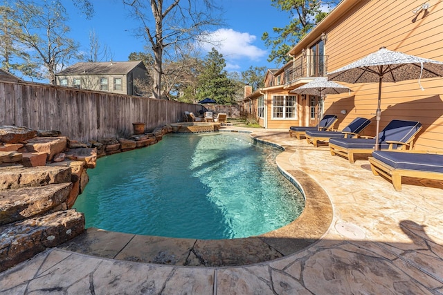 view of pool featuring a patio area, a fenced backyard, and a fenced in pool