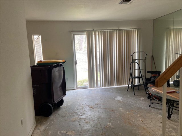 interior space featuring unfinished concrete floors and visible vents