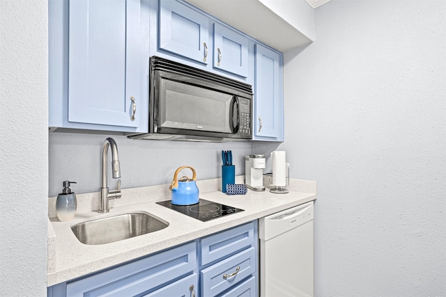 kitchen featuring sink, blue cabinetry, and black appliances